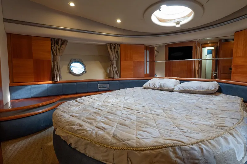 Slide: The Image of Luxurious bedroom interior of 2008 Azimut Fly 50 yacht with round bed and porthole window. - 14