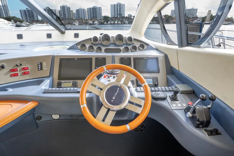 Slide: The Image of Cockpit of 2008 Azimut Fly 50 yacht with modern controls and city skyline view. - 7