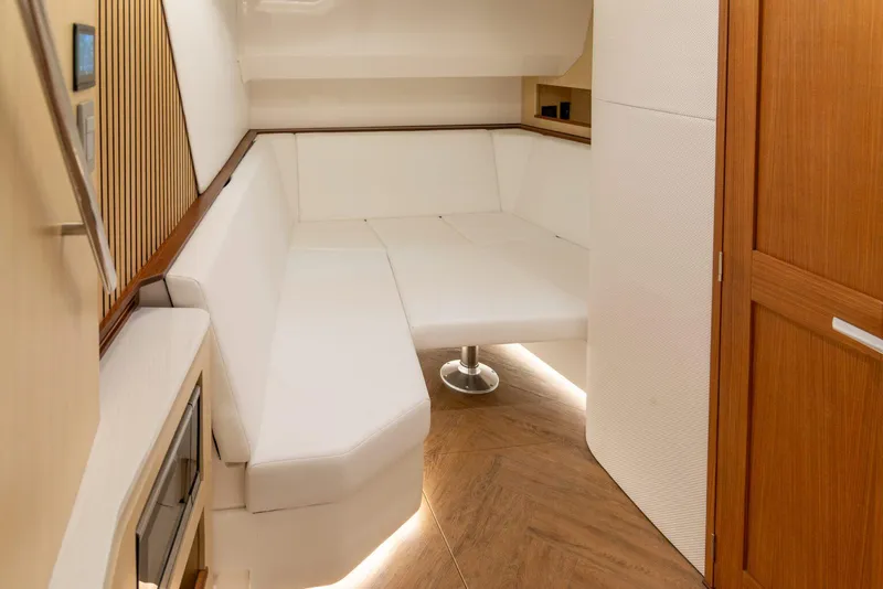 Slide: The Image of Manufacturer Provided Image: Luxurious interior of 2026 Regal 50 SAV yacht with white seating and wooden accents. - 12