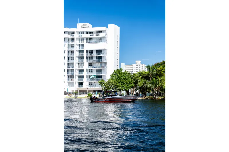 Slide: The Image of Boat on water near modern white building, AMP 333 model, 2026. - 3