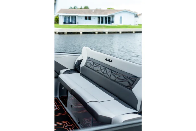Slide: The Image of Modern AMP 333 boat interior with stylish seating, overlooking a serene waterfront view. - 8