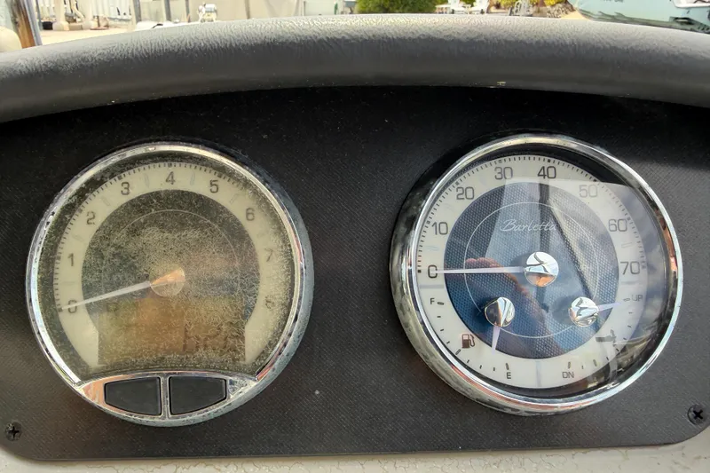 Slide: The Image of Dashboard gauges of a 2021 Barletta C20UC boat, showing speedometer and tachometer. - 12