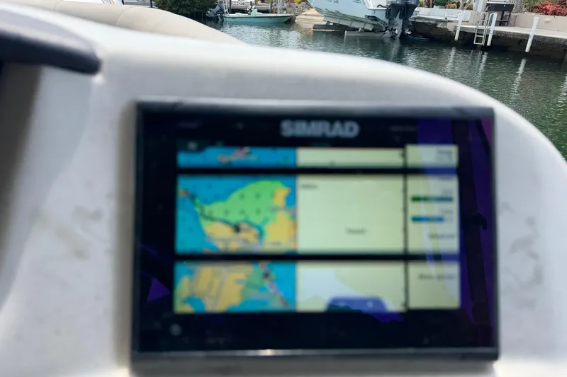 Slide: The Image of Simrad navigation display on a 2021 Barletta C20UC boat, docked near water. - 14