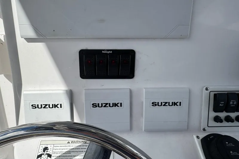 Slide: The Image of Control panel of a 2017 Pro-Line 26 Super Sport boat with Suzuki components. - 12