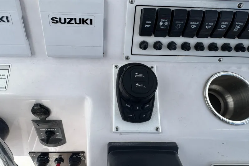 Slide: The Image of Control panel of a 2017 Pro-Line 26 Super Sport boat with Suzuki components. - 14