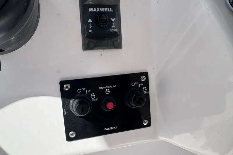 Slide: The Image of Control panel of a 2017 Pro-Line 26 Super Sport boat with Suzuki ignition. - 15