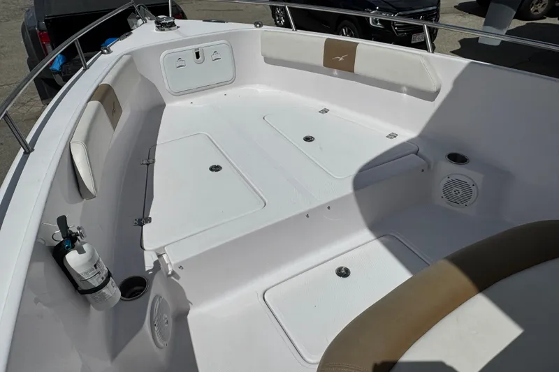 Slide: The Image of 2017 Pro-Line 26 Super Sport boat interior with seating and storage compartments. - 16