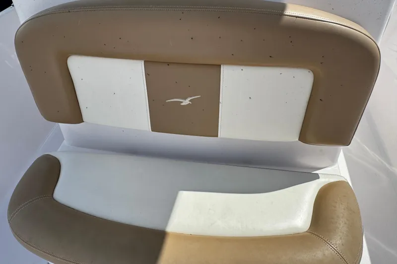 Slide: The Image of 2017 Pro-Line 26 Super Sport boat seat with tan and white upholstery. - 17