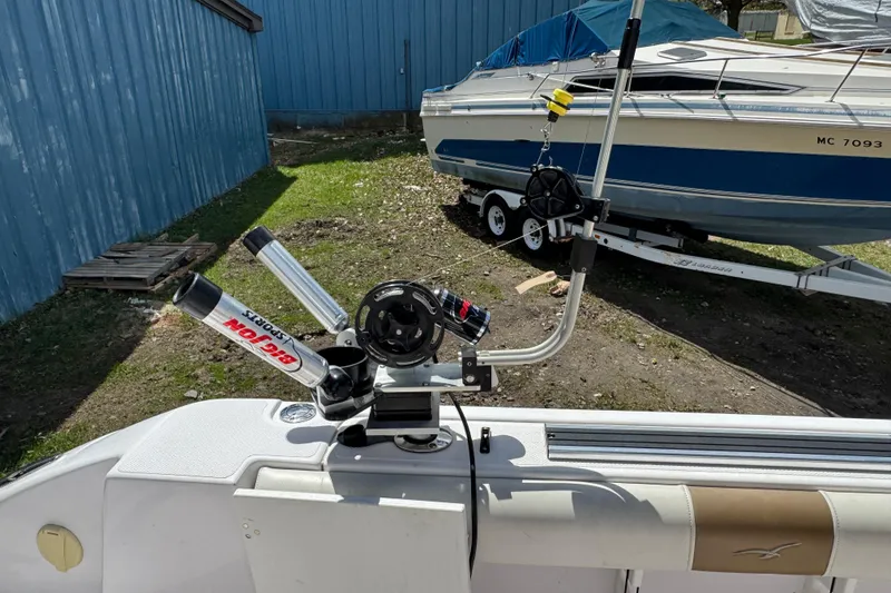 Slide: The Image of 2017 Pro-Line 26 Super Sport boat with fishing rod holders and equipment on deck. - 19