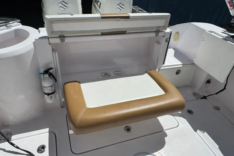 Slide: The Image of 2017 Pro-Line 26 Super Sport boat interior with foldable seat and storage compartments. - 21
