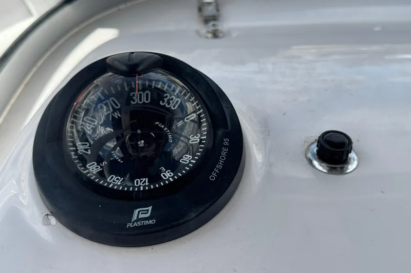 Slide: The Image of Compass on 2017 Pro-Line 26 Super Sport boat dashboard, featuring Plastimo Offshore 95 model. - 22