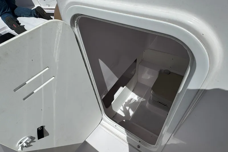 Slide: The Image of Open storage compartment on 2017 Pro-Line 26 Super Sport boat. - 23