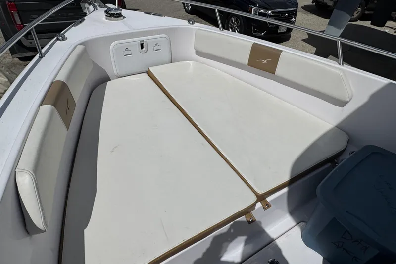 Slide: The Image of 2017 Pro-Line 26 Super Sport boat interior with cushioned seating area. - 24