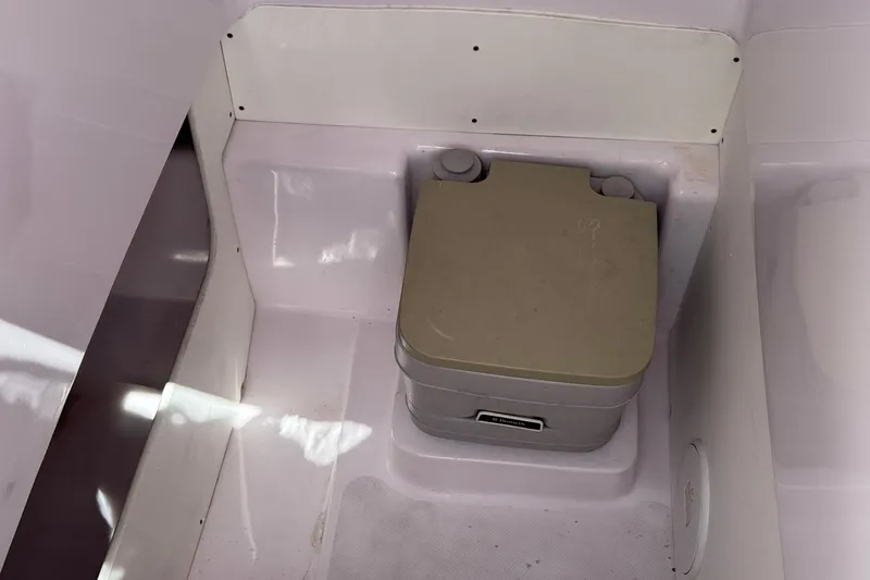 Slide: The Image of Portable toilet in 2017 Pro-Line 26 Super Sport boat interior. - 25