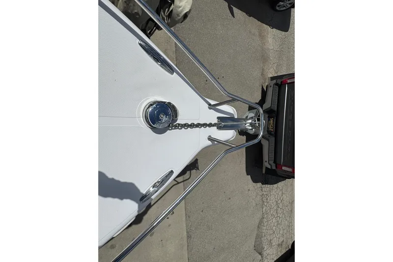 Slide: The Image of Bow view of 2017 Pro-Line 26 Super Sport boat with anchor chain and trailer. - 26