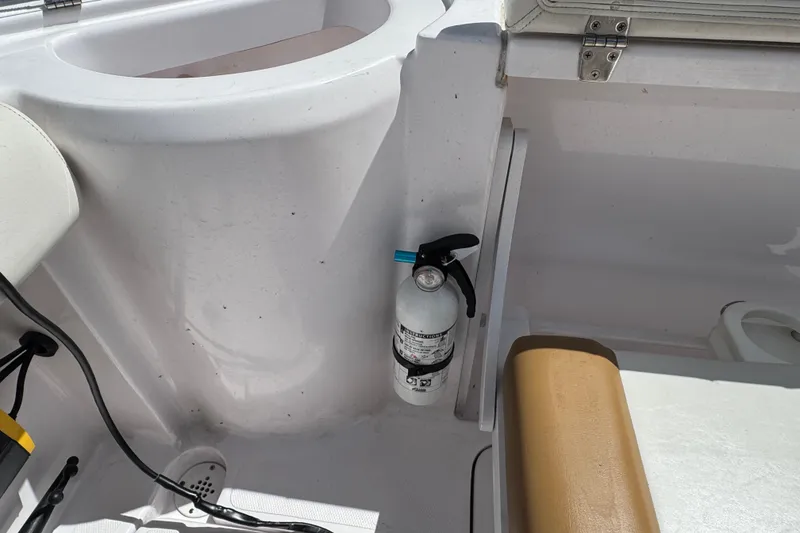 Slide: The Image of Fire extinguisher on 2017 Pro-Line 26 Super Sport boat interior. - 28