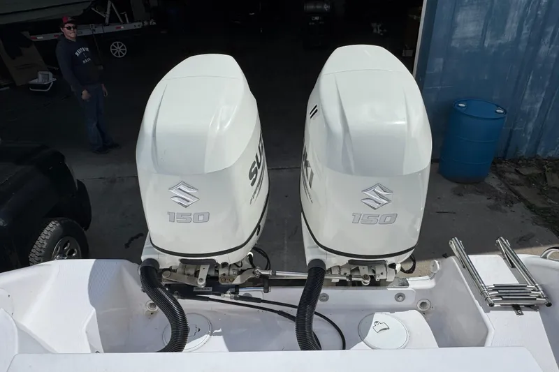 Slide: The Image of Twin Suzuki 150 outboard engines on a 2017 Pro-Line 26 Super Sport boat. - 4