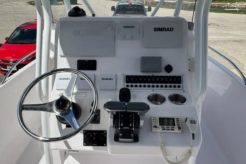 Slide: The Image of 2017 Pro-Line 26 Super Sport boat dashboard with steering wheel and control panel. - 7