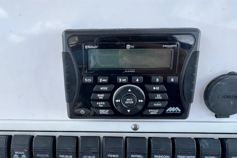 Slide: The Image of Marine audio system on 2017 Pro-Line 26 Super Sport boat dashboard. - 9