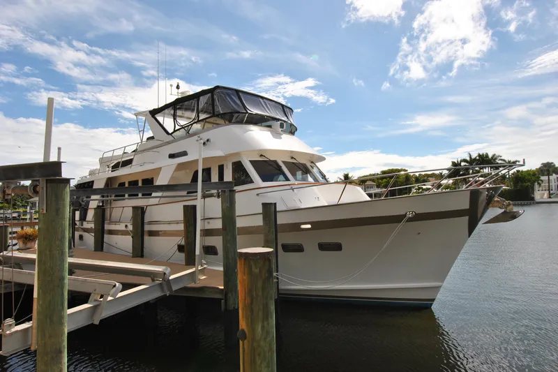 Slide: The Image of 2002 Grand Alaskan Cockpit Motor Yacht docked under a clear blue sky. - 1