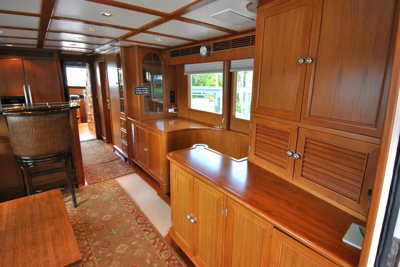 Slide: The Image of Luxurious wooden interior of a 2002 Grand Alaskan Cockpit Motor Yacht, featuring elegant cabinetry. - 10