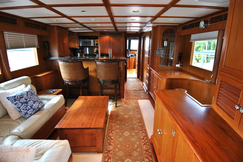 Slide: The Image of Luxurious 2002 Grand Alaskan Cockpit Motor Yacht interior with elegant wood finishes and cozy seating. - 11