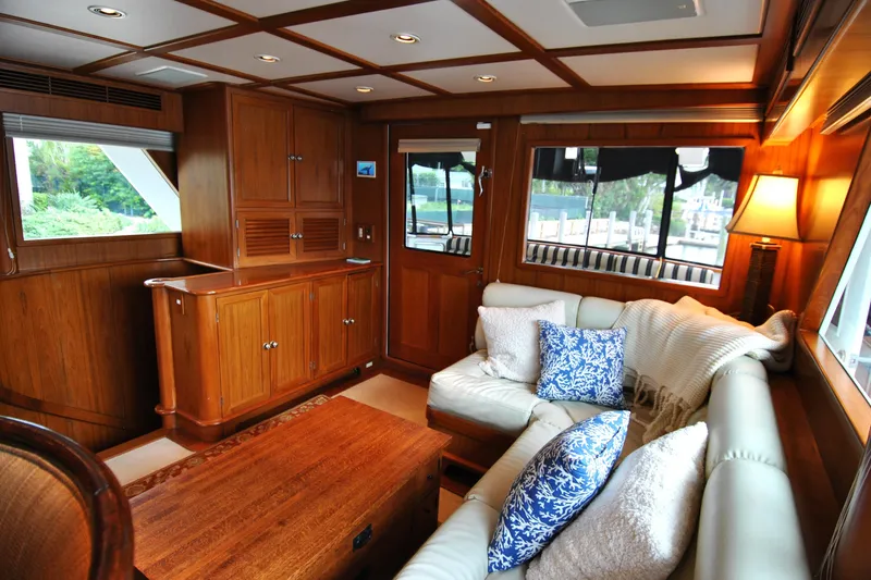 Slide: The Image of Luxurious 2002 Grand Alaskan Cockpit Motor Yacht interior with elegant wood paneling and cozy seating. - 12