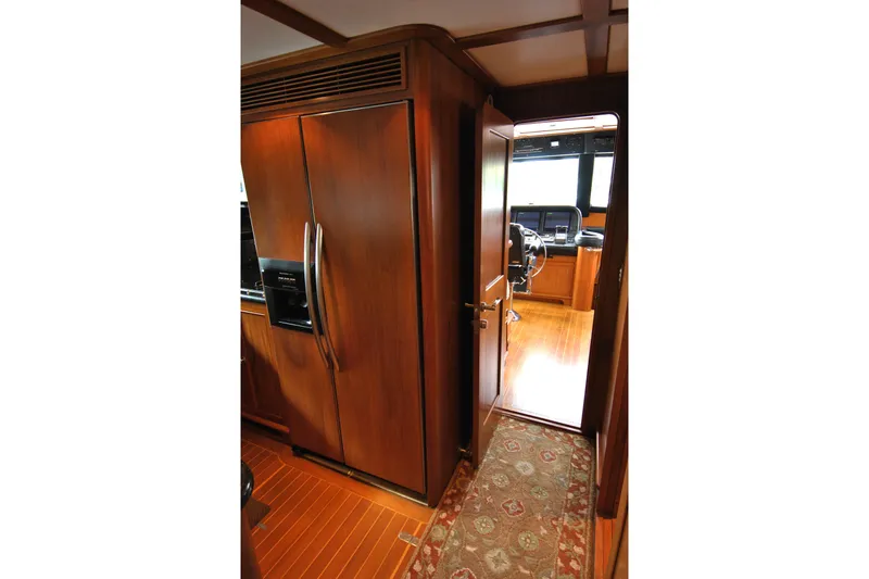 Slide: The Image of Interior of 2002 Grand Alaskan Cockpit Motor Yacht with wooden cabinetry and helm view. - 16