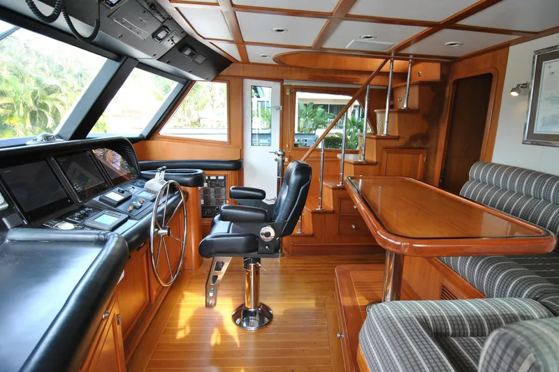 Slide: The Image of Luxurious 2002 Grand Alaskan Cockpit Motor Yacht interior with helm, seating, and wooden finishes. - 20