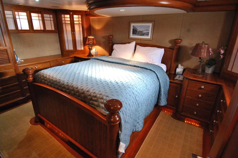 Slide: The Image of Luxurious 2002 Grand Alaskan Cockpit Motor Yacht bedroom with elegant wood furnishings. - 24