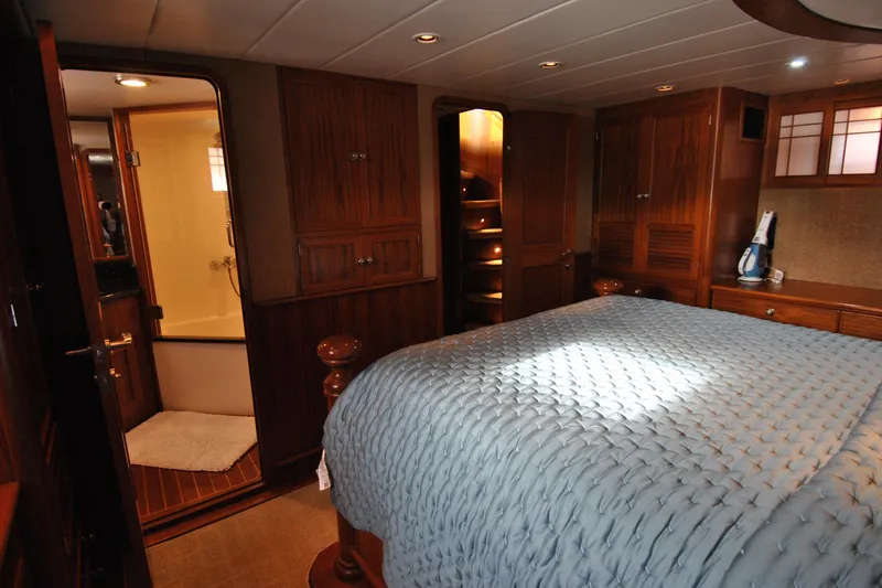 Slide: The Image of Luxurious 2002 Grand Alaskan Cockpit Motor Yacht bedroom with elegant wood cabinetry. - 27
