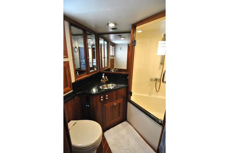 Slide: The Image of Luxurious bathroom in 2002 Grand Alaskan Cockpit Motor Yacht with wood accents and modern fixtures. - 28