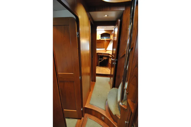 Slide: The Image of Interior hallway of 2002 Grand Alaskan Cockpit Motor Yacht with wooden finishes. - 31