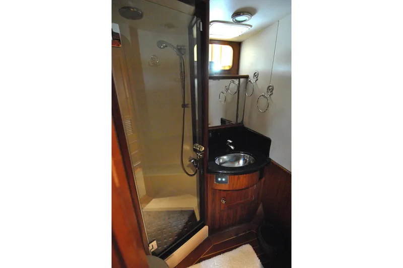 Slide: The Image of Bathroom interior of 2002 Grand Alaskan Cockpit Motor Yacht with shower and sink. - 34