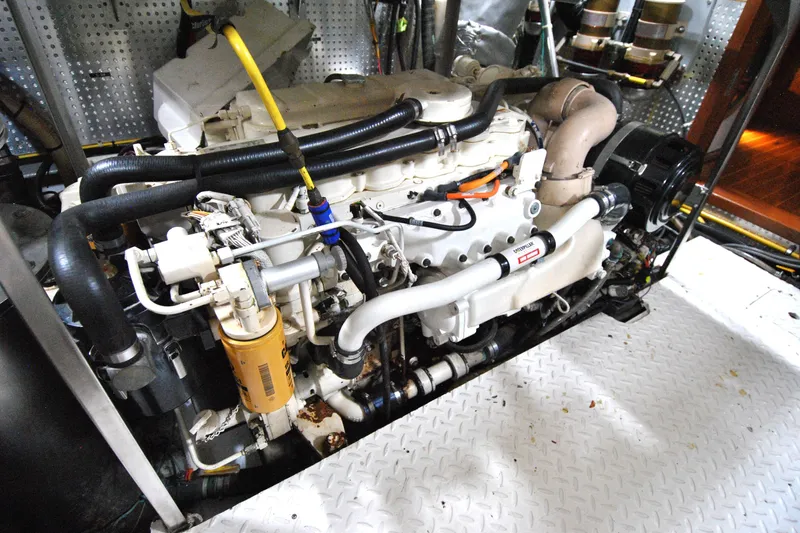 Slide: The Image of Engine room of a 2002 Grand Alaskan Cockpit Motor Yacht, showcasing detailed machinery. - 37