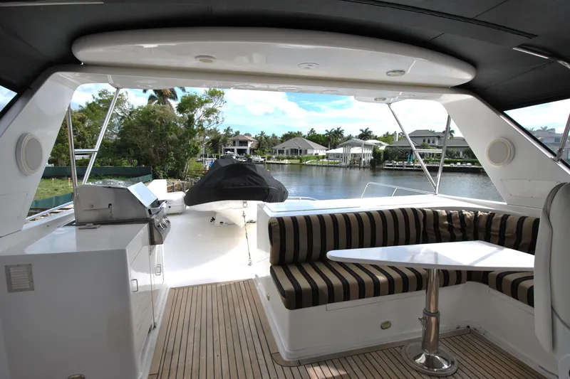 Slide: The Image of Luxurious 2002 Grand Alaskan Cockpit Motor Yacht with spacious seating and scenic waterfront view. - 40