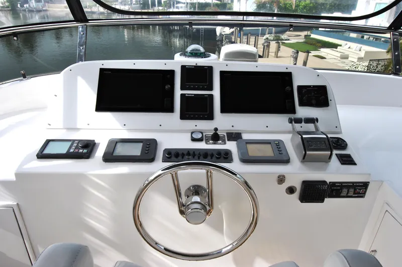 Slide: The Image of Cockpit of 2002 Grand Alaskan Motor Yacht with modern navigation controls and steering wheel. - 42