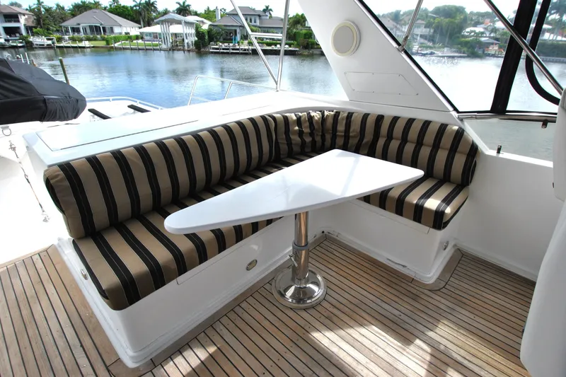 Slide: The Image of Luxurious seating area on 2002 Grand Alaskan Cockpit Motor Yacht with striped cushions. - 43