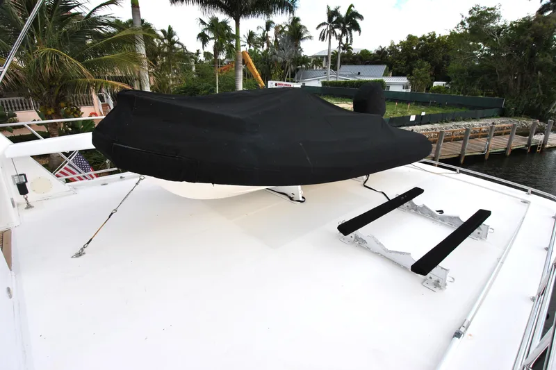 Slide: The Image of 2002 Grand Alaskan Cockpit Motor Yacht deck with covered equipment and dockside view. - 46