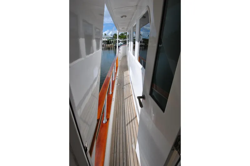 Slide: The Image of Side deck view of 2002 Grand Alaskan Cockpit Motor Yacht with wooden railings. - 47