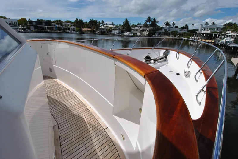 Slide: The Image of 2002 Grand Alaskan Cockpit Motor Yacht with polished wood deck and sleek railing design. - 49