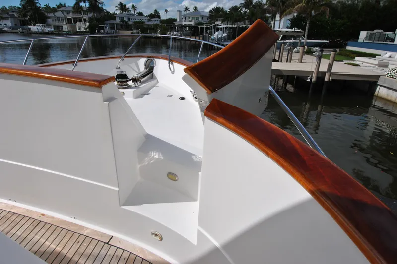 Slide: The Image of 2002 Grand Alaskan Cockpit Motor Yacht with polished wood accents docked by waterfront homes. - 50