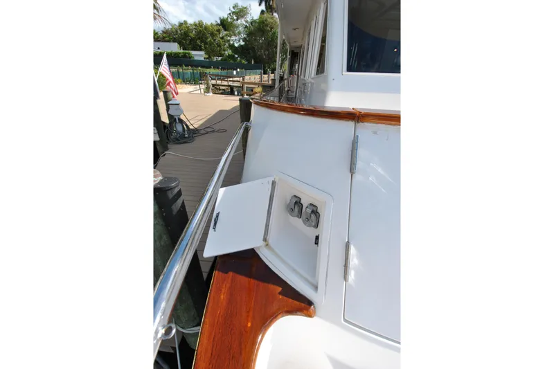 Slide: The Image of 2002 Grand Alaskan Cockpit Motor Yacht with open utility panel on deck. - 52