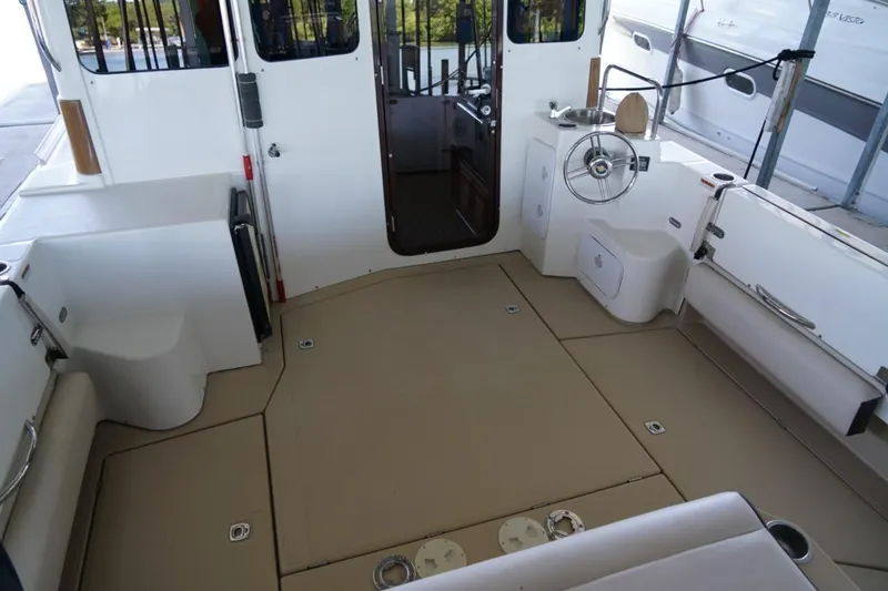Slide: The Image of 2014 Ranger Tugs R-31 boat interior with spacious deck and helm station. - 14