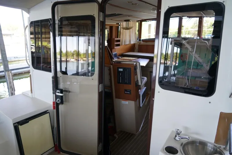 Slide: The Image of Interior view of 2014 Ranger Tugs R-31 boat, featuring cabin entrance and seating area. - 19