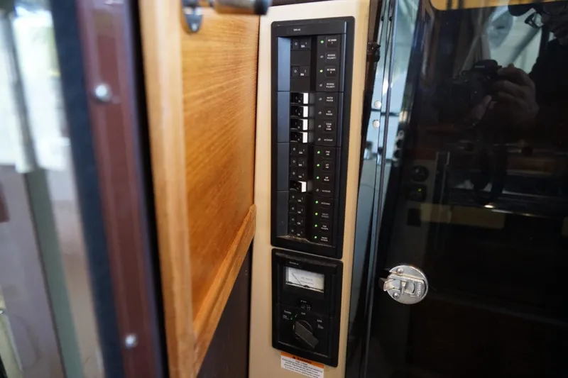 Slide: The Image of Electrical panel inside a 2014 Ranger Tugs R-31 boat, featuring switches and controls. - 21