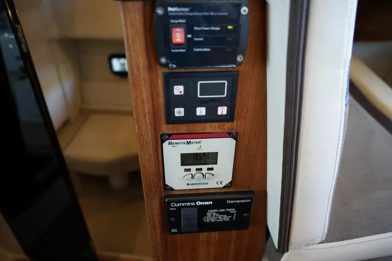 Slide: The Image of Control panel inside 2014 Ranger Tugs R-31 boat, featuring various electronic displays and switches. - 22