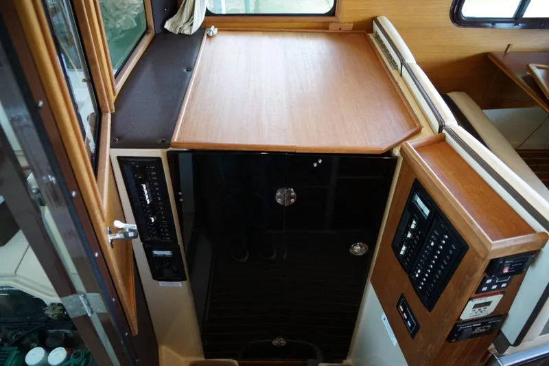 Slide: The Image of Interior view of 2014 Ranger Tugs R-31 boat with control panels and wooden surfaces. - 25