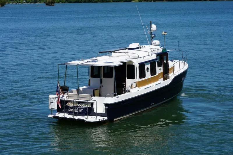 Slide: The Image of 2014 Ranger Tugs R-31 boat cruising on a calm blue lake. - 3