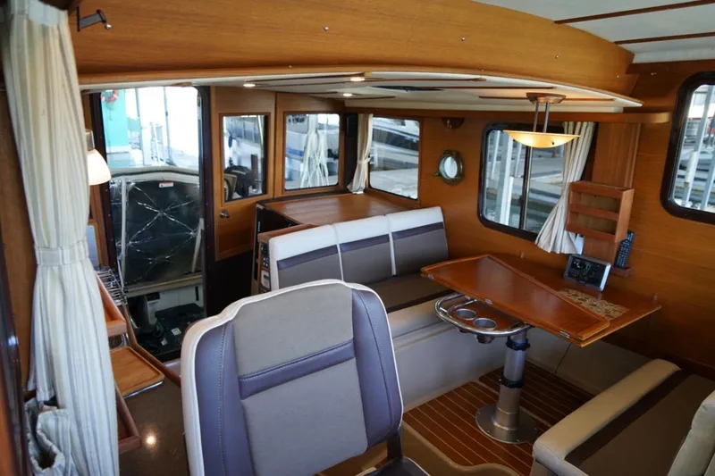 Slide: The Image of Interior of 2014 Ranger Tugs R-31 boat with wood finish and seating area. - 33